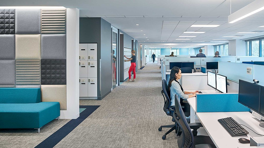 A person sitting at a desk in an office.