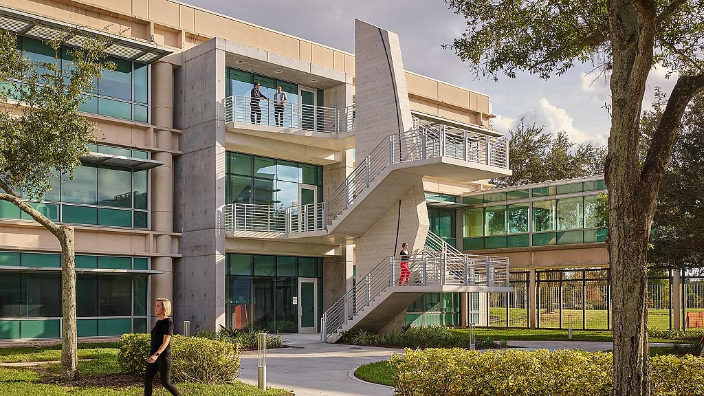 A building with stairs and trees.