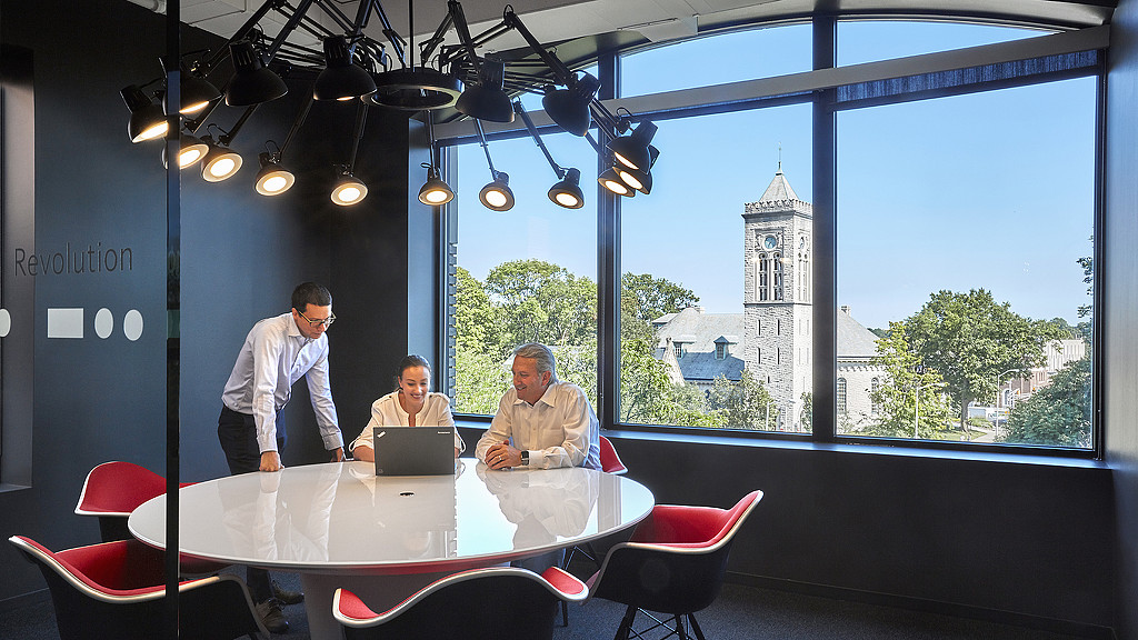 A few men working at a table.