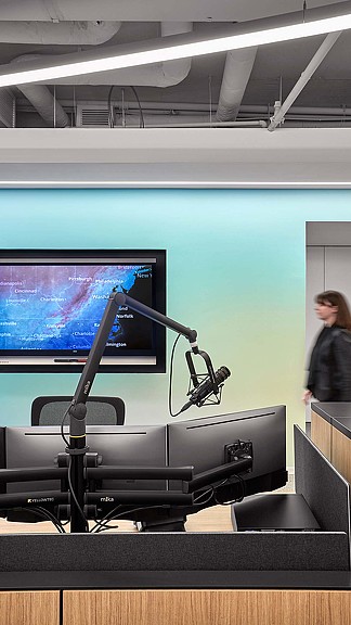 A person standing in front of a screen.