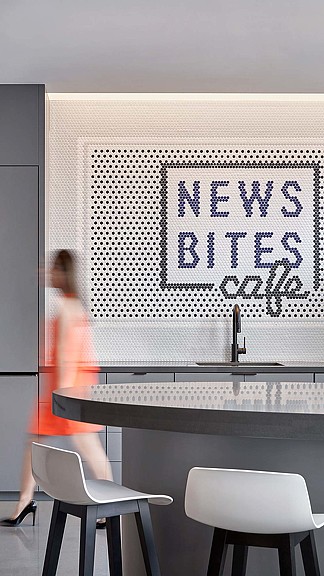 A person standing in front of a white board with writing on it.