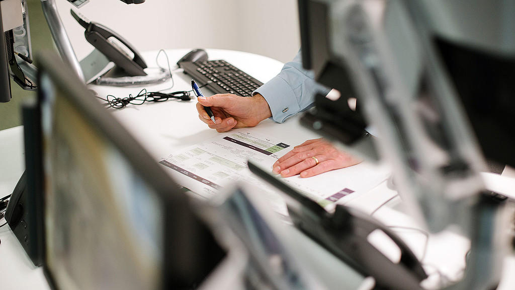 A person writing on a piece of paper.