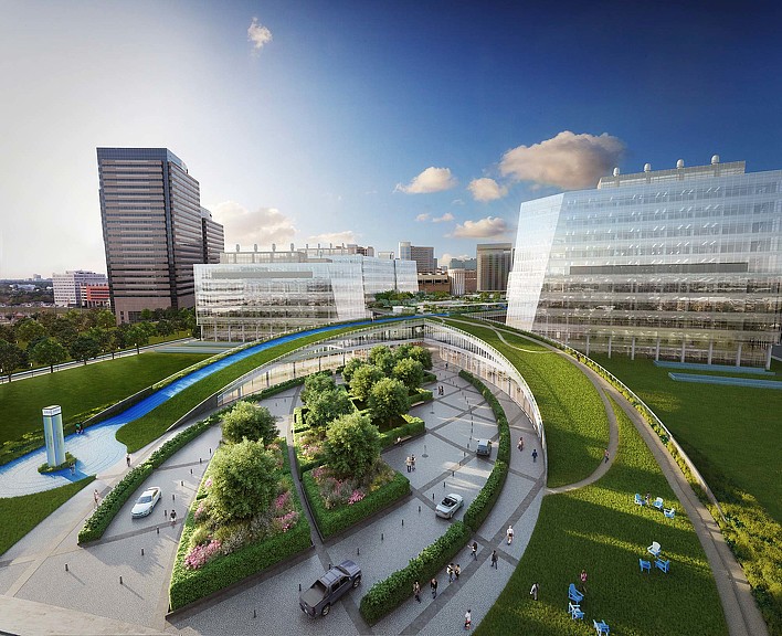 A large courtyard with a pool and buildings in the background.