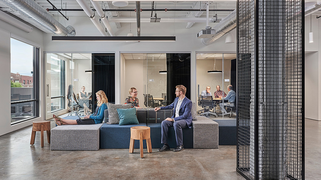 A group of people sitting on a couch in a room.