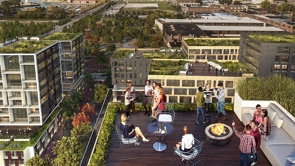 A group of people standing on a balcony overlooking a city.