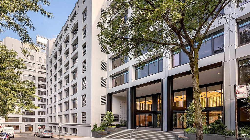 A building with a staircase and trees.