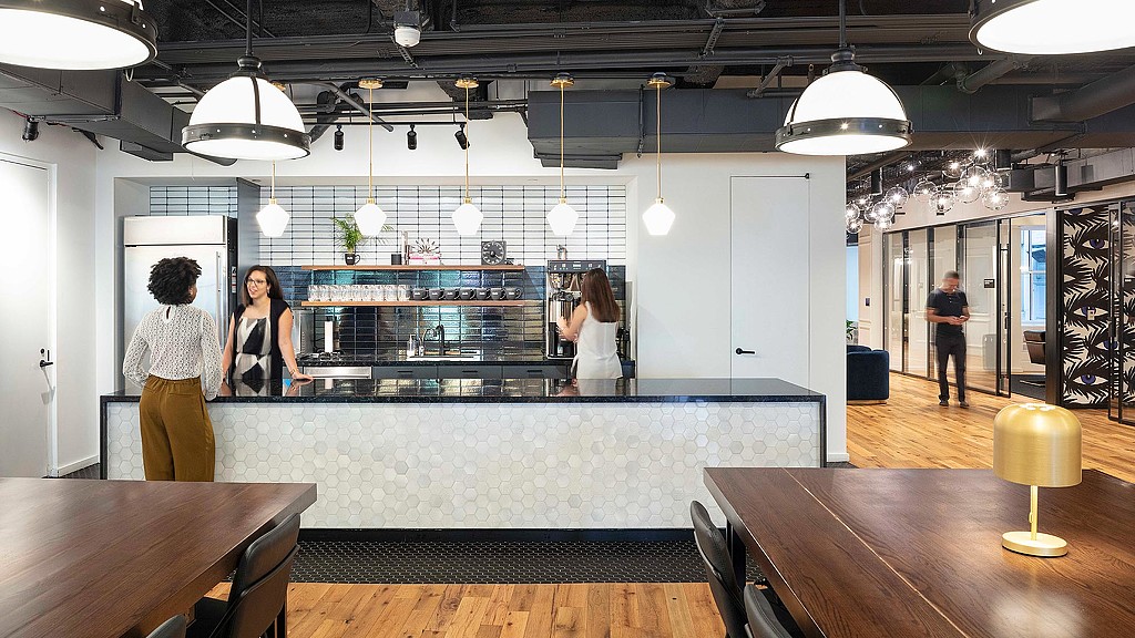 A group of people in a kitchen.