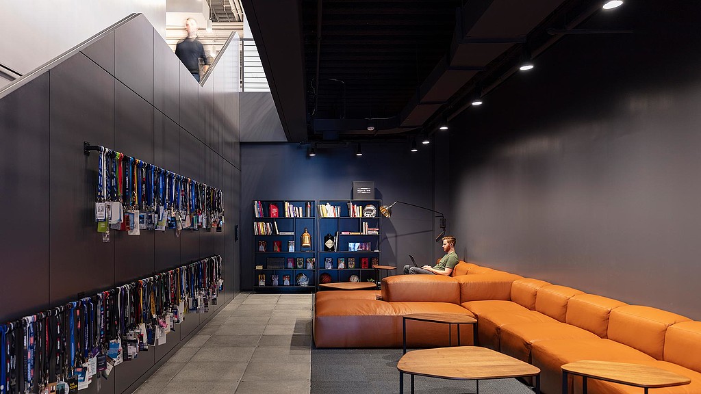 A room with a couch and a table with a person sitting in it.