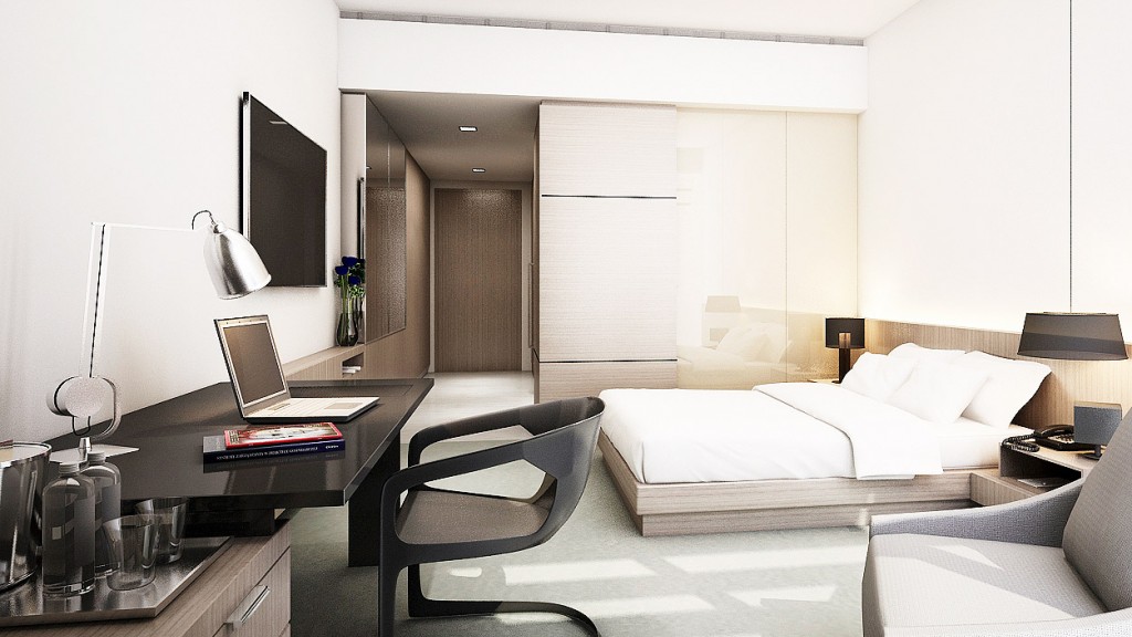 A bedroom with a bed desk and a laptop.