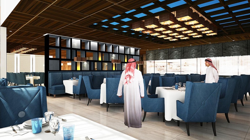 A person standing in a room with tables and chairs.