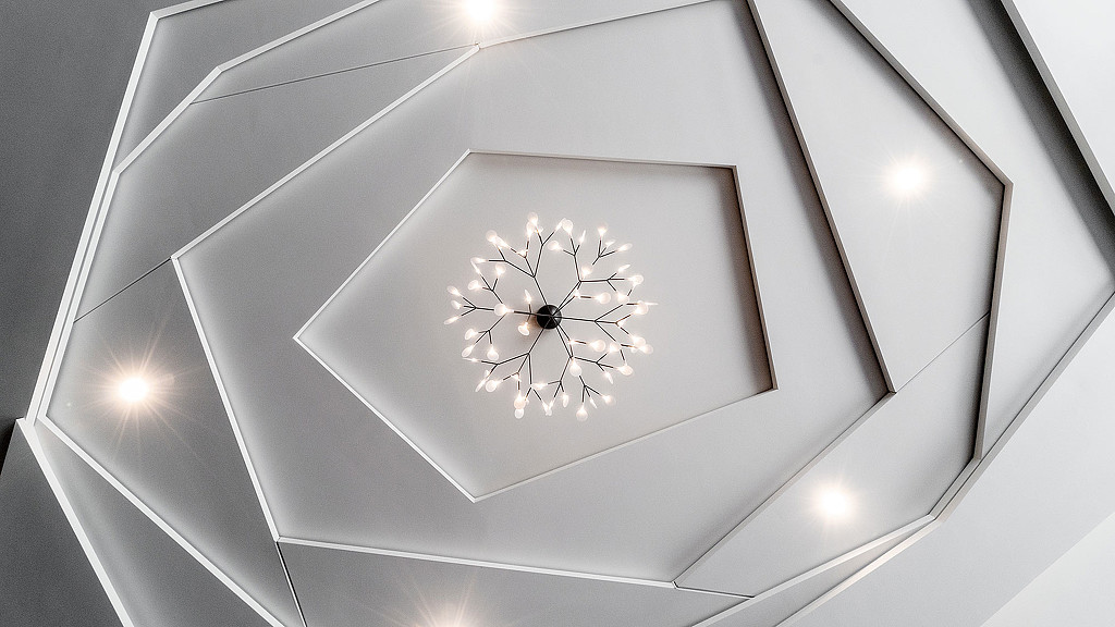 A white ceiling with a round white object on it.