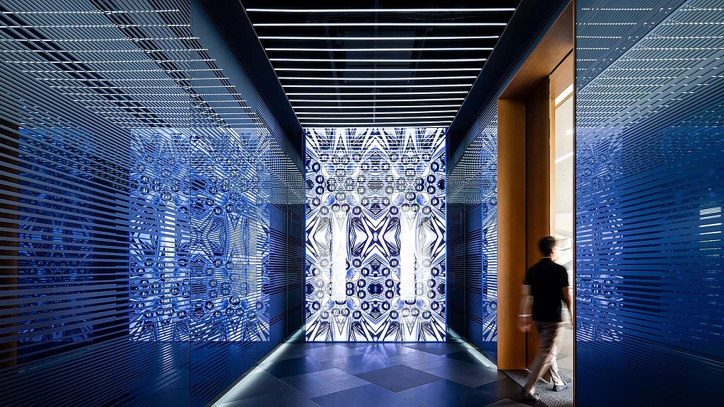 A person walking through a hallway.