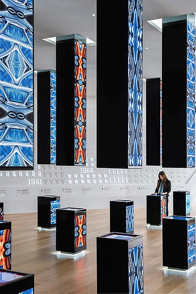 A person standing in front of a large screen.