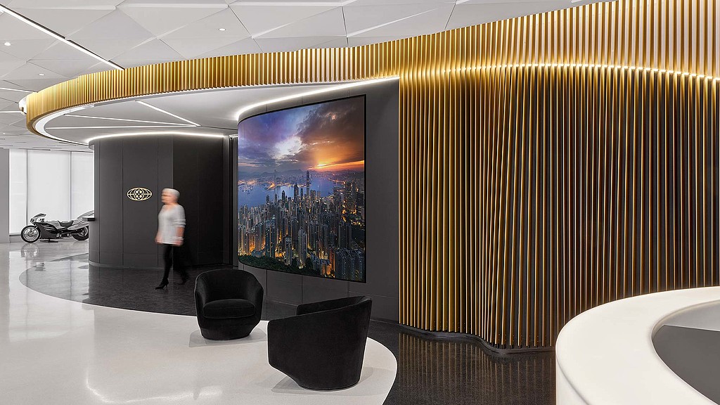 A person standing in front of a large screen.