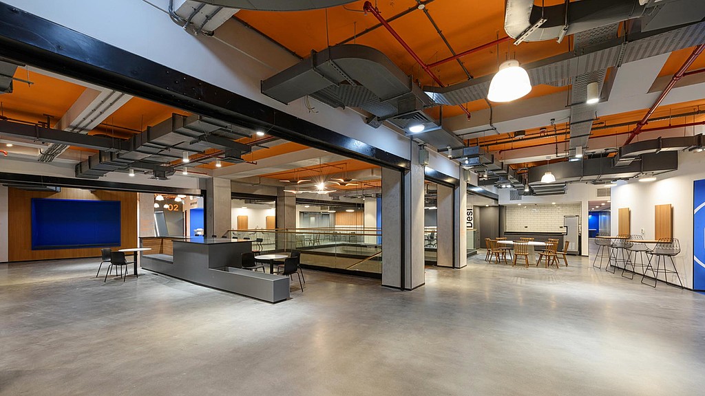 A large room with tables and chairs.