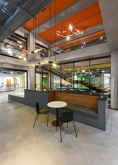 A room with a table chairs and a large glass ceiling.