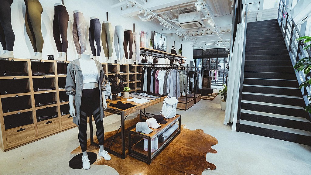 A person standing in a room with a table and chairs.