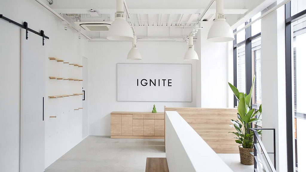 A room with a sign and a plant.