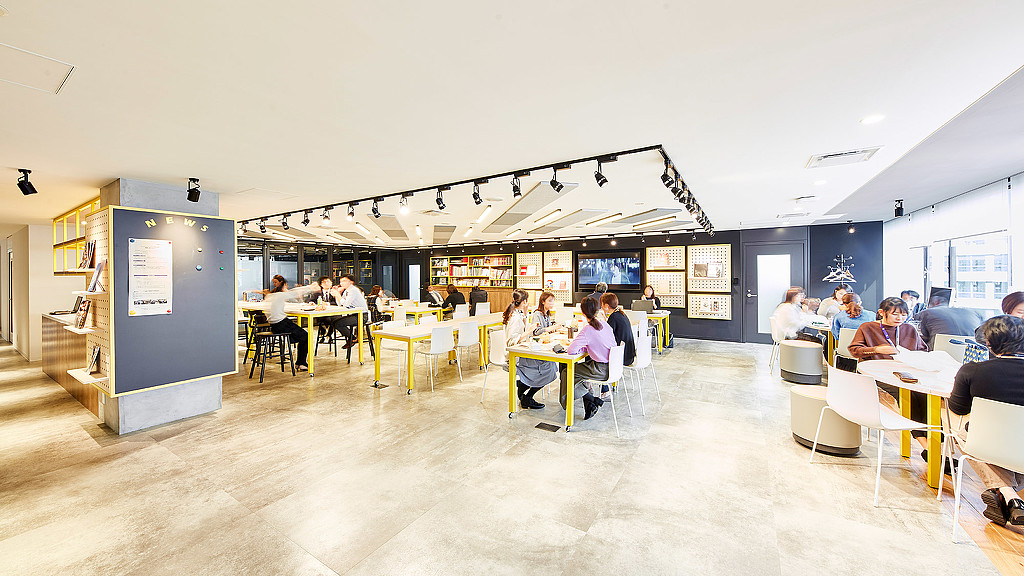 A group of people sitting at tables.