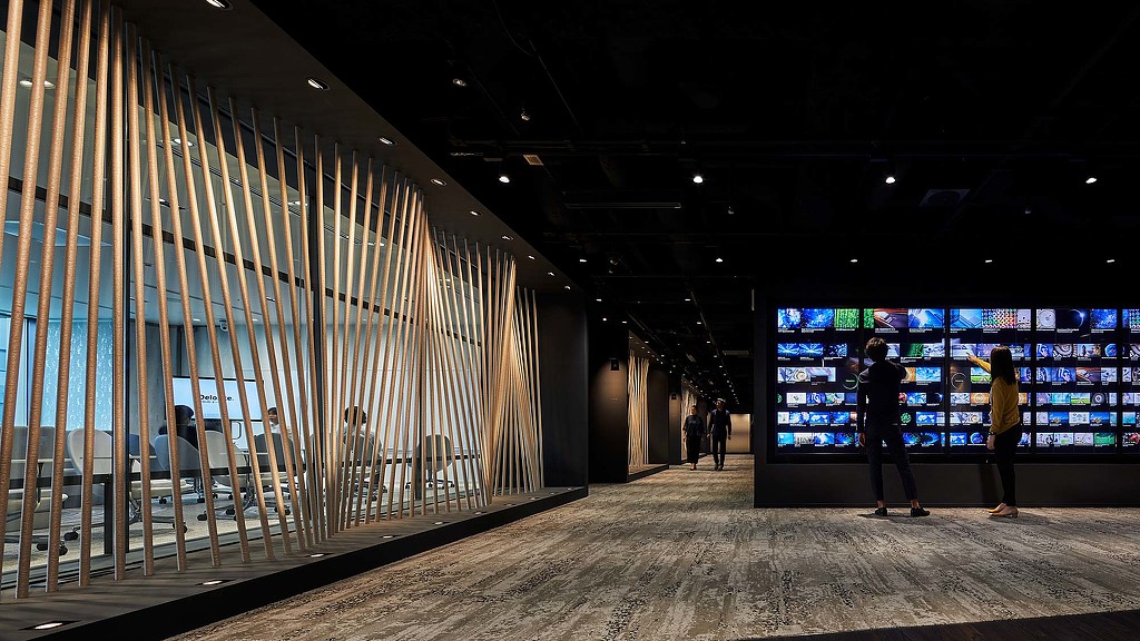 People standing in front of a large screen.