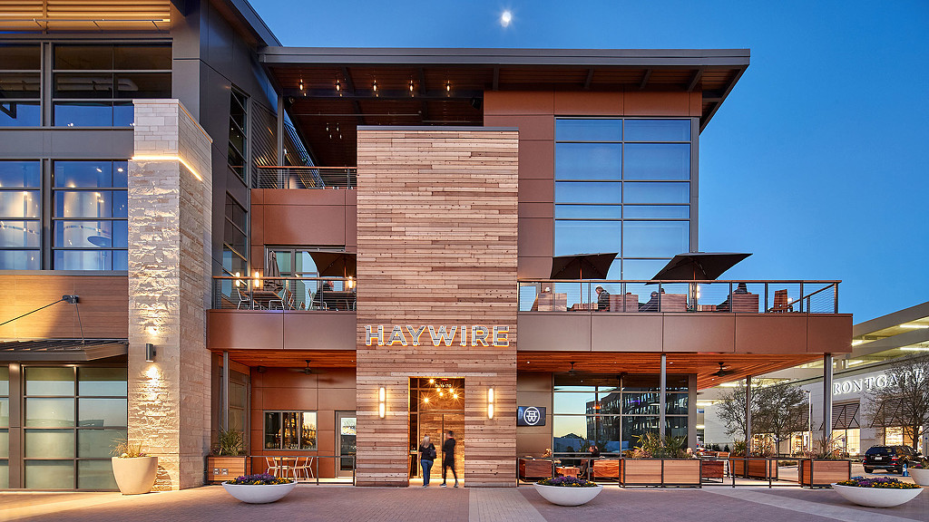 A building with a few people walking out front.