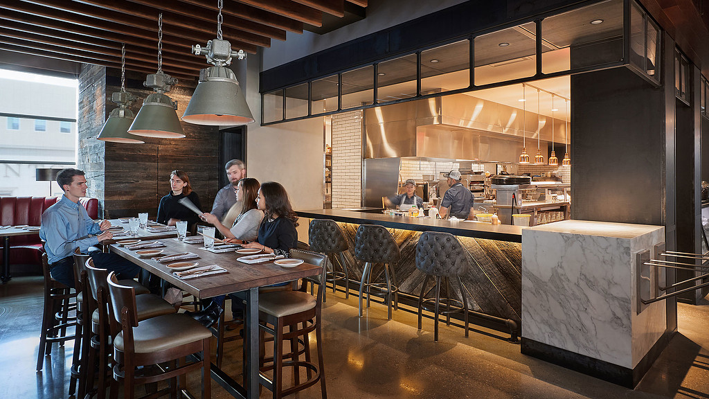 A group of people sitting around a table.