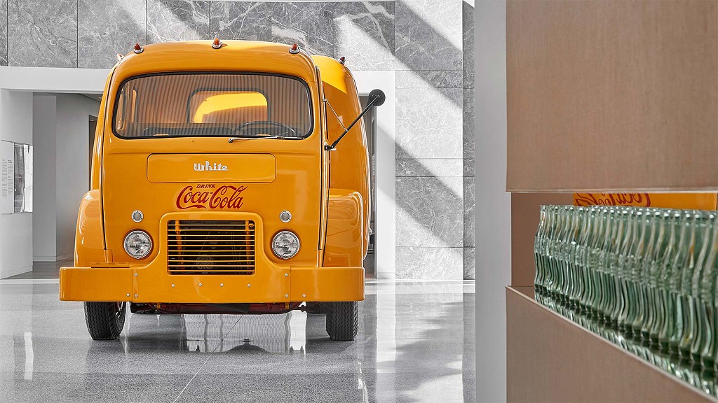 A yellow van parked in a garage.