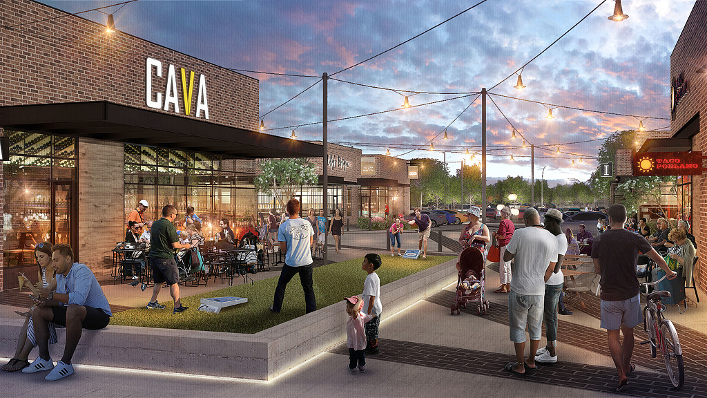 A group of people walking on a street.