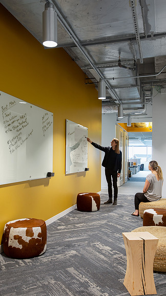 A person pointing to a whiteboard.