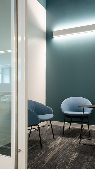 A room with chairs and a window.