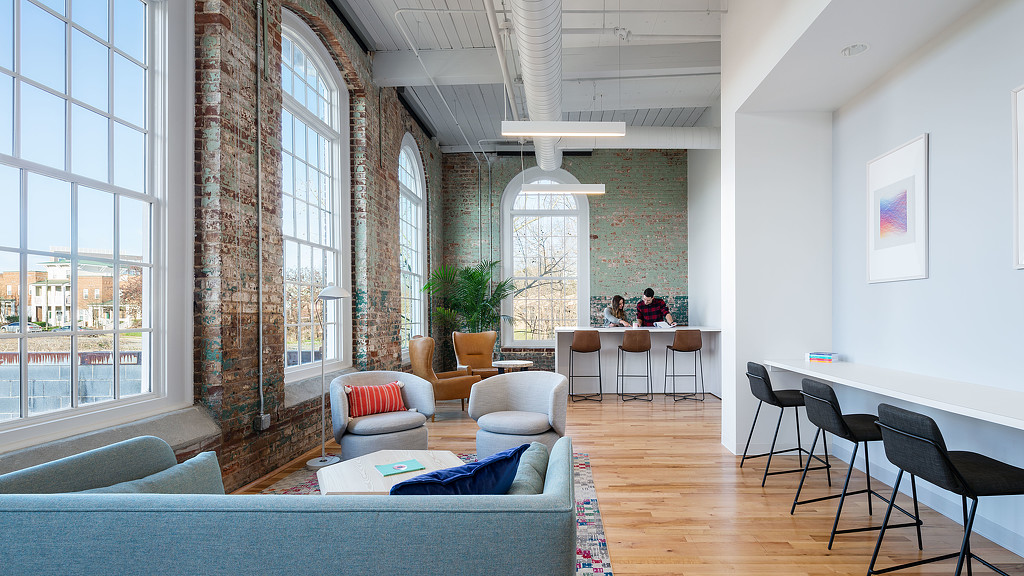 A room with a table chairs and a couch.