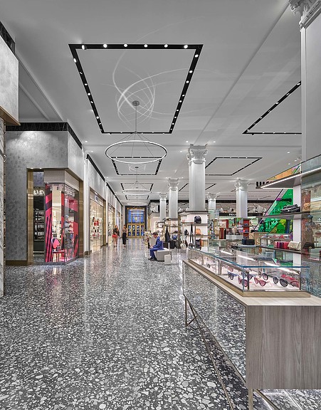A large shopping mall with a large ceiling and many lights.