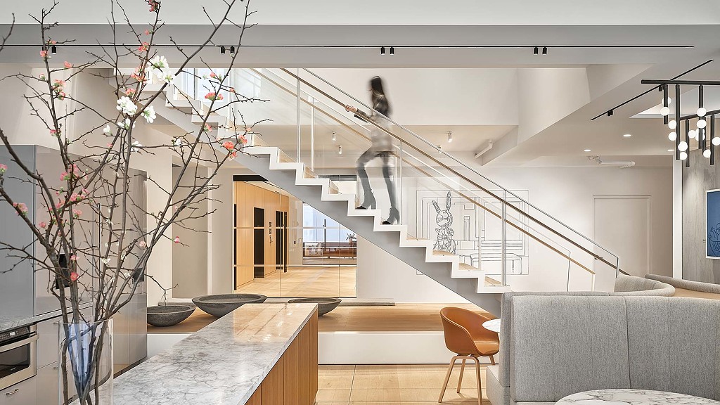 A staircase with a glass wall.