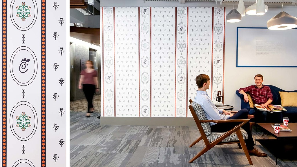 A man sitting in a chair in a room with a woman standing.