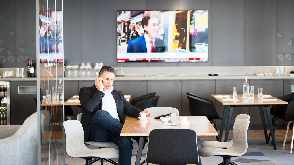 A person sitting at a table in front of a television.