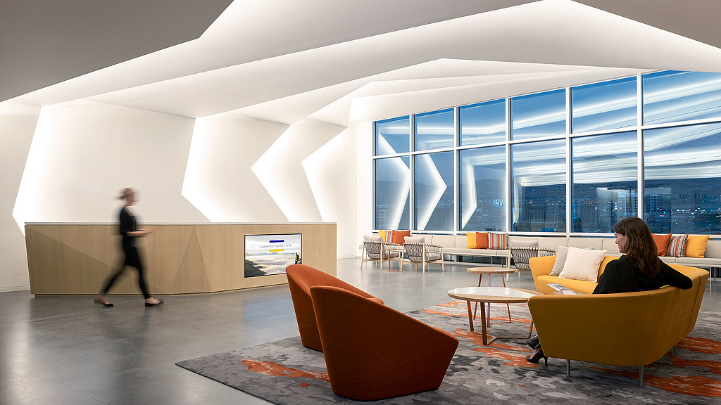 A man and woman in a room with a large window.