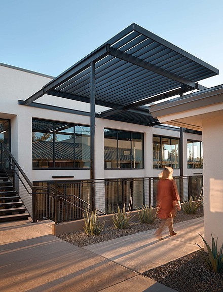 A person walking outside of a building.
