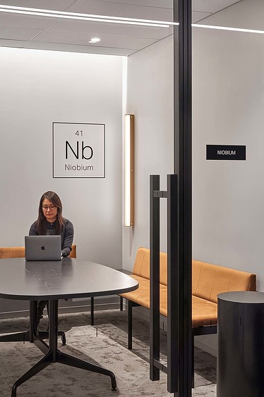 A person sitting at a table with a laptop.