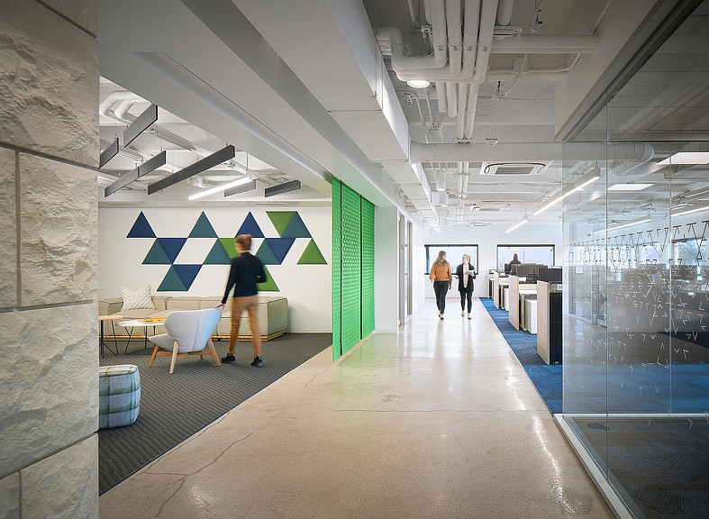 A group of people walking in a building.