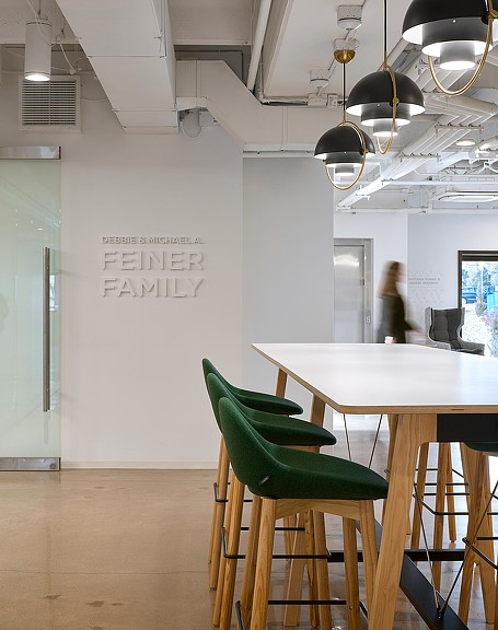 A room with a table chairs and a chandelier.