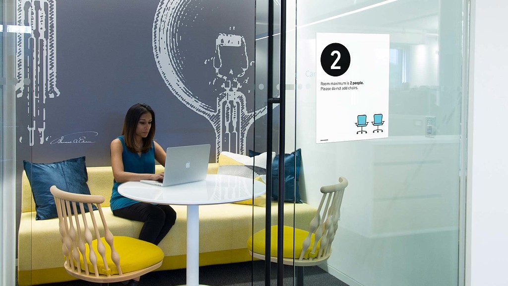 A person sitting at a table with a laptop.