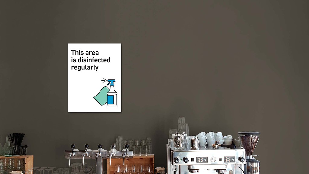 A room with a table and a machine with a sign above it.