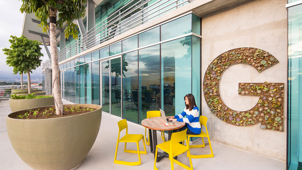 A person sitting at a table outside.