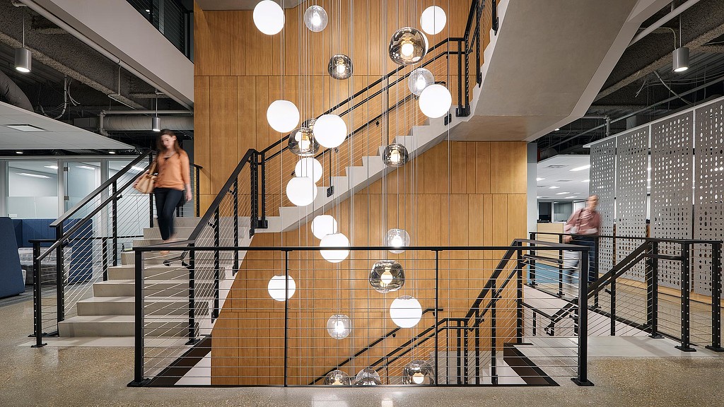 A couple of women walking down a flight of stairs.