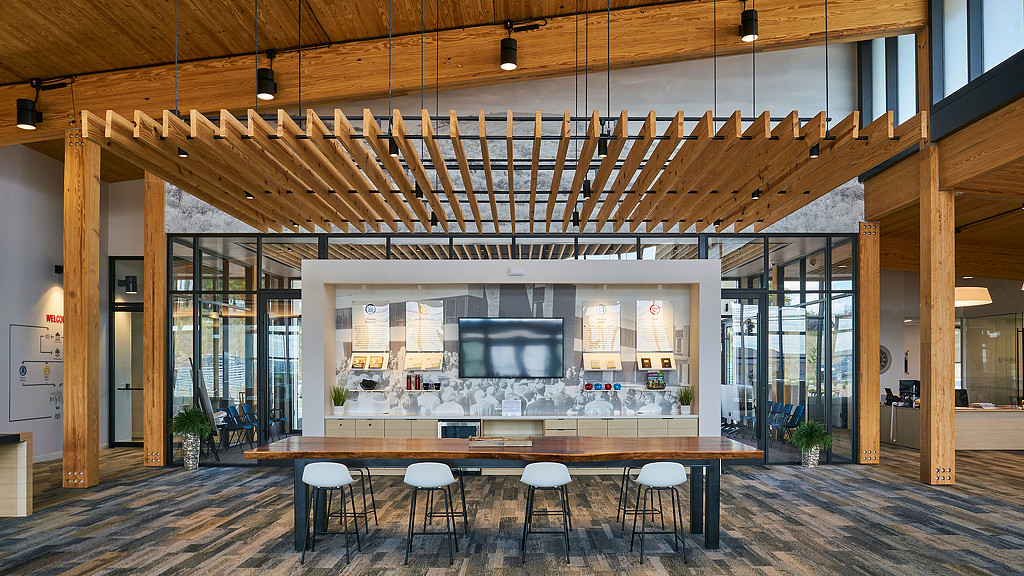 A room with a bar and chairs.