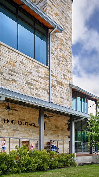 A building with windows and people outside.