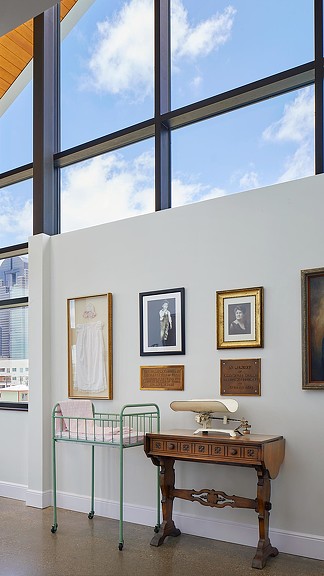 A room with a table and a window with pictures on it.