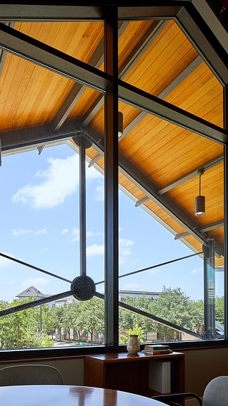 A table and chairs in front of a window.