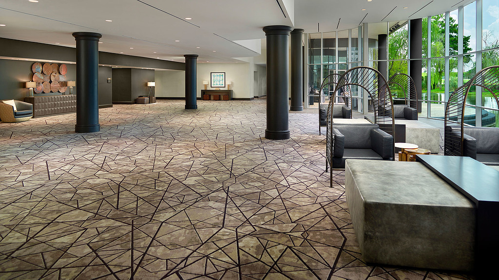 A room with a large stone floor and a large glass wall.
