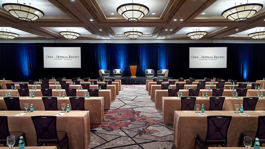 A room with chairs and a screen.